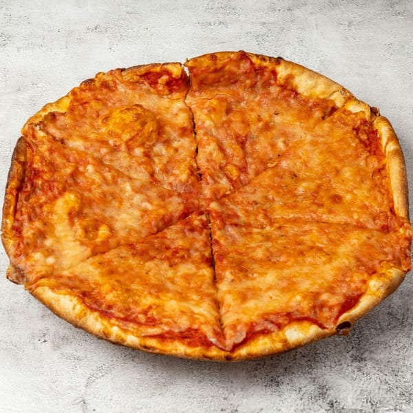 A whole cheese pizza, cut into six slices, on a light gray textured surface.